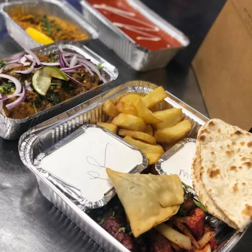 a tray of food with a sandwich and french fries at 4 Sisters Inn in North Kyme