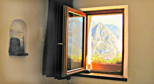 a window with a view of a mountain at Chambre des pierres, Cadre Magnifique au Cœur du Verdon in Castellane