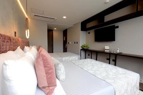 Ένα ή περισσότερα κρεβάτια σε δωμάτιο στο The O by Seekers Medellín