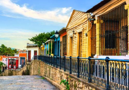 a fence in front of a row of houses at JM GUESTHOUSE Colonial in Santo Domingo