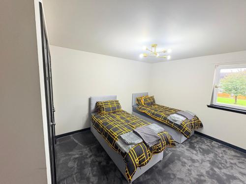 a bedroom with two beds and a window at F1 2BR Free Parking Walk Dist CityC in Glasgow