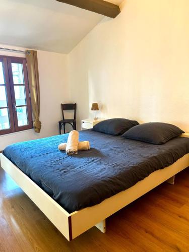 a bedroom with a large bed with a stuffed animal on it at Petit Patapon - T2 Hyper Centre in Albi