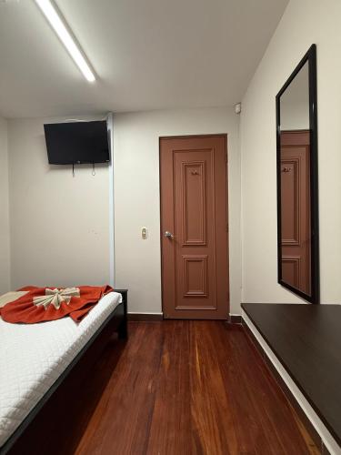 a room with a bed and a mirror and a door at Harmony Hotel by Haven in San José