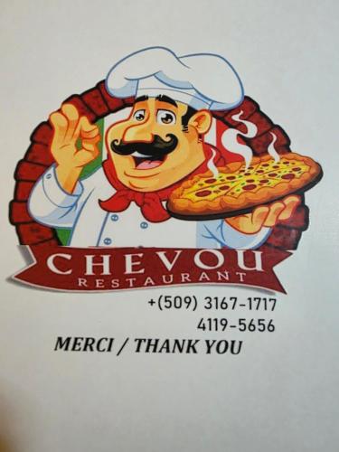 a sticker of a chef holding a pizza at Vivy Hill's Hotel in Port-au-Prince