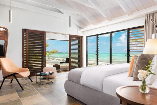 a bedroom with a bed and a view of the ocean at Spectacular spacious 8 bedroom family villa in Providenciales