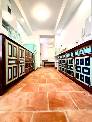 a room with a tiled floor and a couch at Casa Basilia in Granada