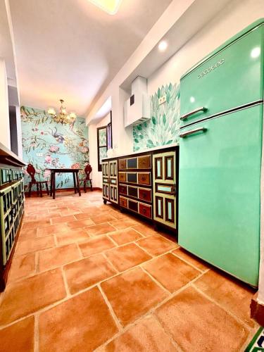 a kitchen with a large refrigerator and a table at Casa Basilia in Granada
