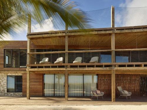 a building with two chairs sitting in front of it at Spectacular spacious 8 bedroom family villa in Providenciales