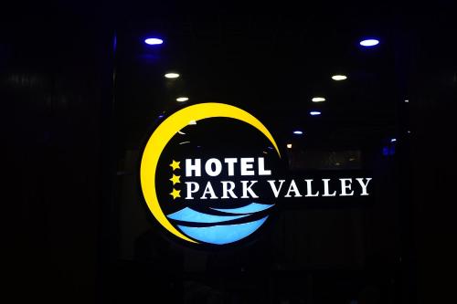 a hotel park valley sign in the dark at Hotel Park Valley International in Ābdullāpur