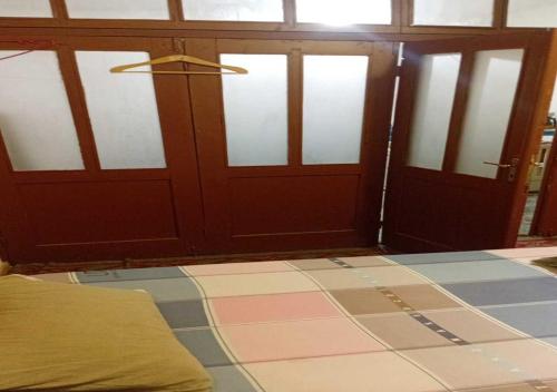 a room with two doors and a bed in front at Business Hostel in Korçë