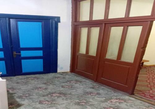 an empty room with two doors and a carpet at Business Hostel in Korçë