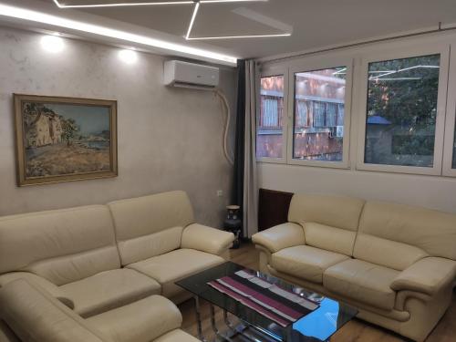 a living room with two couches and a table at Parkside retreat in Belgrade
