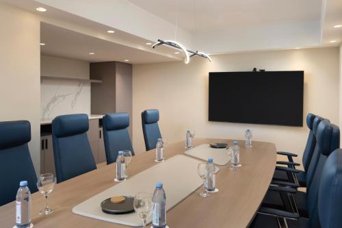 a conference room with a table and chairs and a tv at Royal Beach Hotel Punta Cana, A JdV by Hyatt in Punta Cana