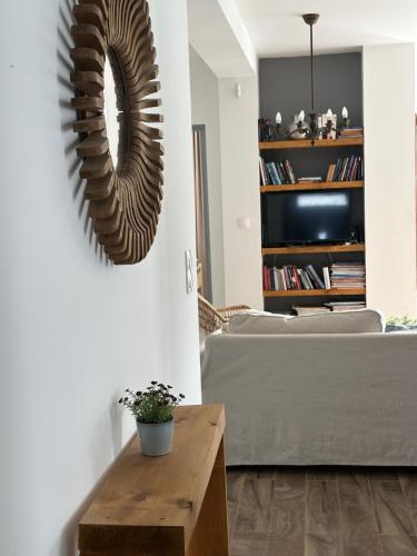a living room with a large mirror on the wall at Berkenye Vendégház Tisza-tó in Abádszalók