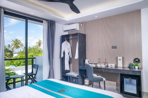 a hotel room with a bed and a bathroom with a sink at Sunwave Dhigurah in Dhigurah