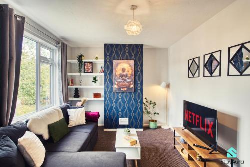 a living room with a couch and a tv at Flat By Stay Aura Short Term Lets Newcastle With Free WiFi & Parking in Kenton