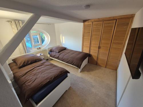 a small bedroom with two beds and a window at Hostelion in Magdeburg