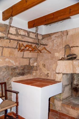 a fireplace in a room with a stone wall at Isla privada, Menorca in Fornells