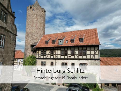 an old building with a tower and a castle at STORCHENNEST - Scandi Style - in der historischen Hinterburg Schlitz - mit Aufzug, Parkplatz & Garten - nahe Fulda und Bad Hersfeld in Schlitz