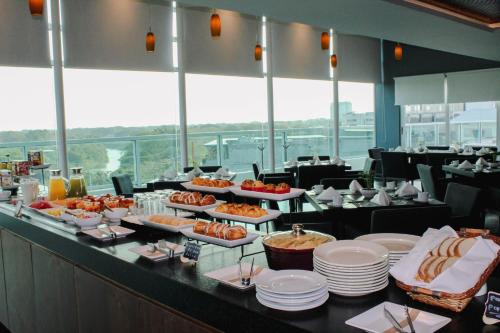 a buffet line with plates of food in a restaurant at Crowne Plaza Villahermosa by IHG in Villahermosa