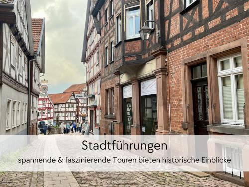 a city street with buildings and the words stablished immigrant at STORCHENNEST - Scandi Style - in der historischen Hinterburg Schlitz - mit Aufzug, Parkplatz & Garten - nahe Fulda und Bad Hersfeld in Schlitz