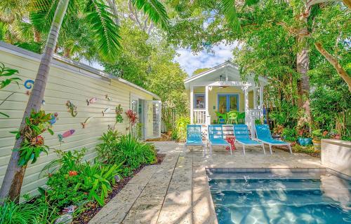 a home with a swimming pool in front of a house at Bahama House in Key West