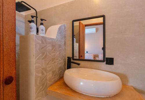 a bathroom with a sink and a mirror at Mayssa Villa in Paje