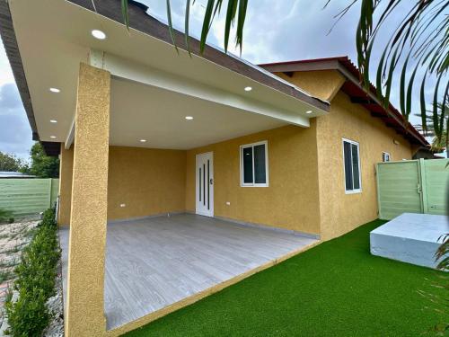 a house with a large patio in front of it at Casa Papilon Family Home in Santa Cruz