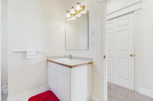 a white bathroom with a sink and a mirror at Wakefield House in Newport