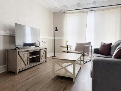 a living room with a large flat screen tv at Cherry Street Retreat in Evansville