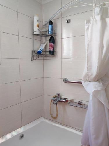 a bathroom with a shower with a tub at Studio in Agrinion