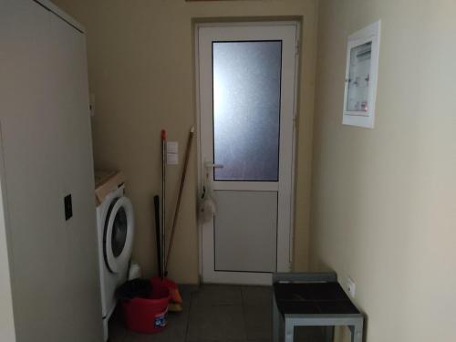a bathroom with a door and a washing machine at Studio in Agrinion