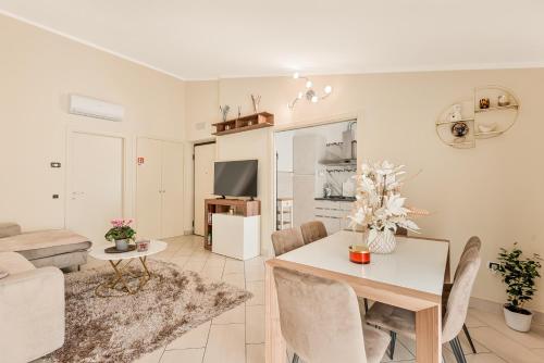 a dining room and living room with a table and chairs at Prestige Apartments in Viareggio