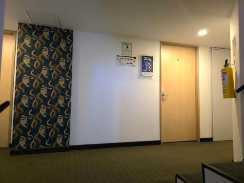 a hallway with a door and a wall with a curtain at Hotel Castellana 95 Bogota By Hoteles Confort 80 in Bogotá