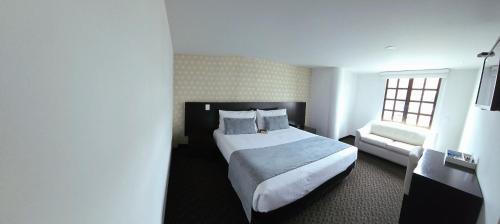 a hotel room with a bed and a window at Hotel Castellana 95 Bogota By Hoteles Confort 80 in Bogotá