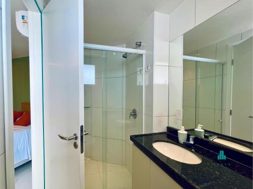 a bathroom with a sink and a glass shower at Aquarius Style by Holiday Stays in Fortaleza