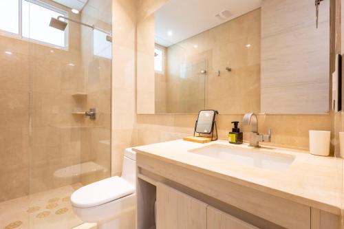 a bathroom with a sink and a toilet and a shower at New! 3BR Ocean View apt at Calablanca B6 in Pendales