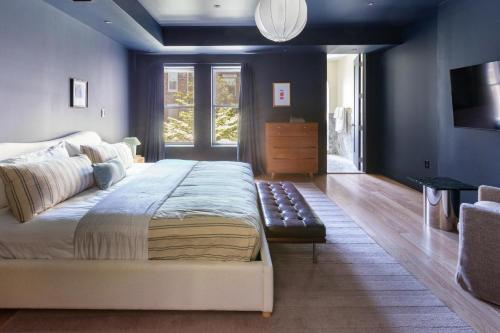 a bedroom with a large bed and a couch at 3.8 Million Dollar Brownstone Newly Renovated in New York