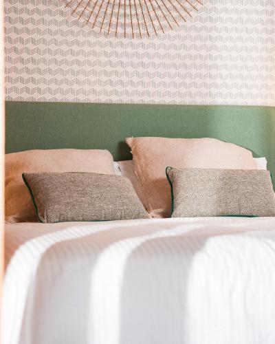 a bed with two pillows on top of it at Hotel Spa Los Mercaderes in Talavera de la Reina