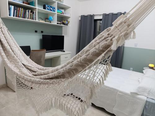 a bedroom with a hammock bed and a desk at COP 30 Luxury home in Belém! in Belém
