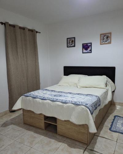 a bedroom with a large bed with a black headboard at Garage y Patio Privado en Salta Casa Completa in Salta