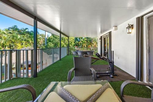 a patio with a table and chairs on a balcony at Cherry RoyaleGrand Villa in Davie