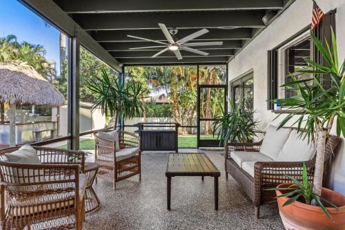a screened in porch with chairs and a table at Cherry RoyaleGrand Villa in Davie