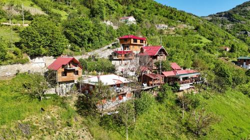 a group of houses on the side of a hill at İsgobya Dağ Evleri 107 in Macka