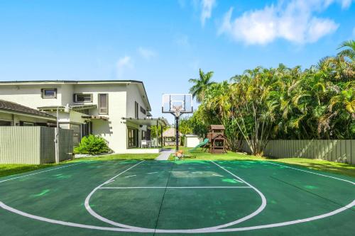 a basketball court in front of a house with a basketball hoop at Cherry RoyaleGrand Villa in Davie