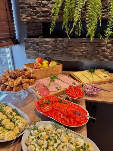 a buffet with different types of food on a table at Płonia Resort in Szczecin