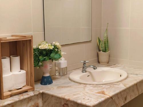 a bathroom counter with a sink and a mirror at Danita's Home Bangkok in Bangkok