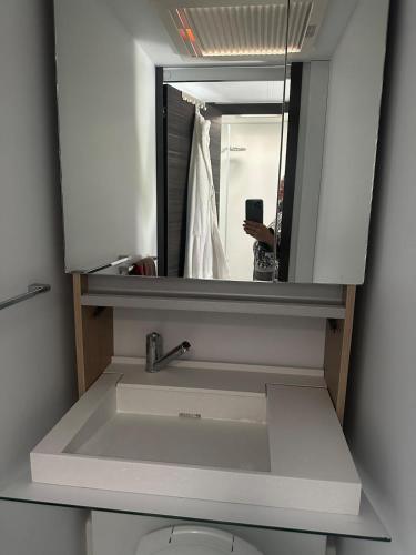 a person taking a picture of a sink in a bathroom at Beautiful, luxurious Caravane property in Rothrist