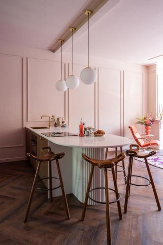 a kitchen with a table and two stools at Luxurious boutique apartment near city centre in Groningen