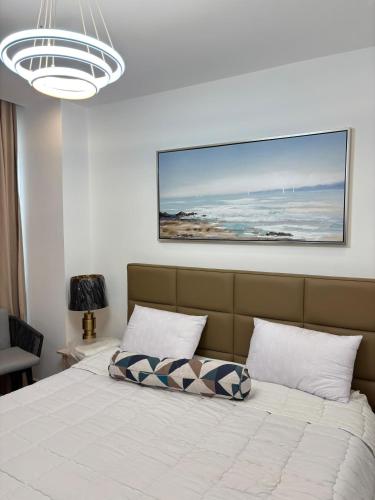 a bedroom with a bed with a picture on the wall at Real Homes 2 bedroom Nova Apartments in Accra